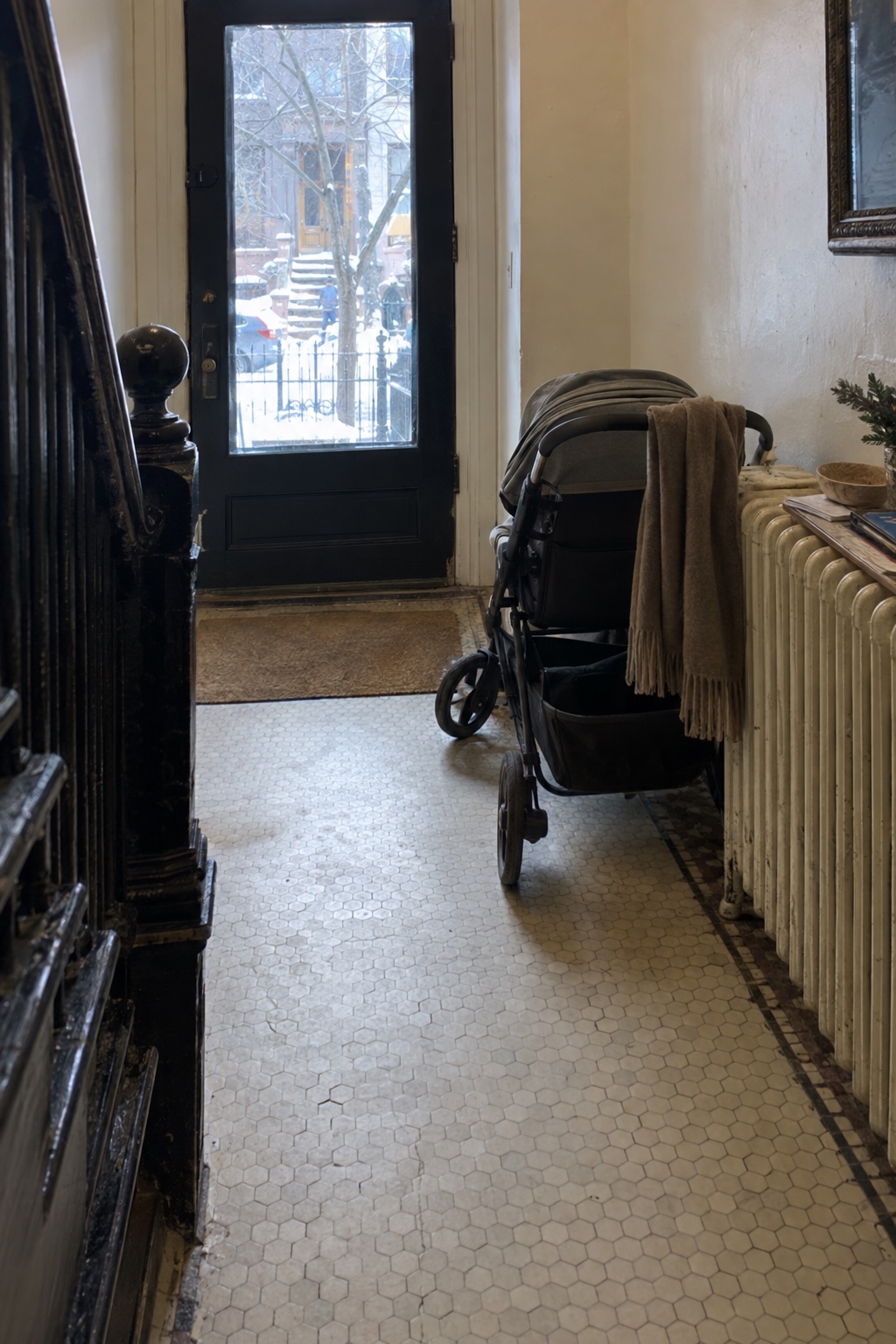 A stroller parked in the hallway of a Brooklyn brownstone